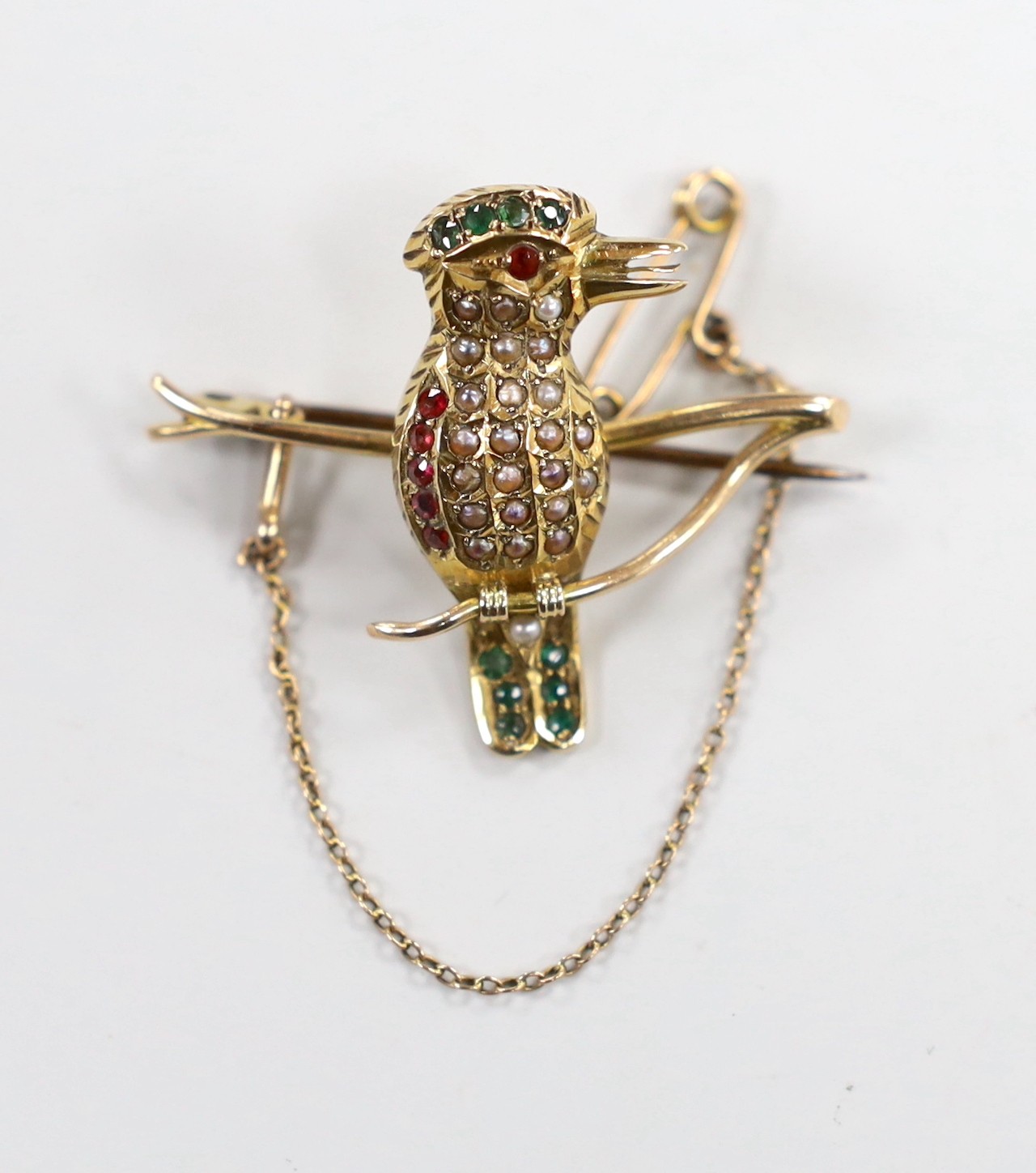 A yellow metal, split pearl ruby and emerald set Kingfisher? bar brooch, length 39mm, gross weight 6.9 grams.